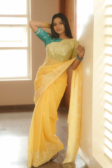 Mesmerizing Yellow Tissue Silk embellished Saree with classic turquoise green hand crafted blouse