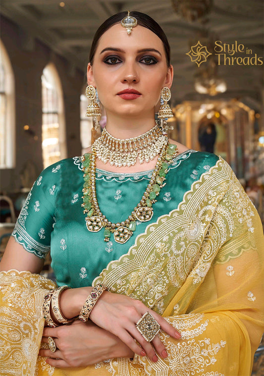 Mesmerizing Yellow Tissue Silk embellished Saree with classic turquoise green hand crafted blouse