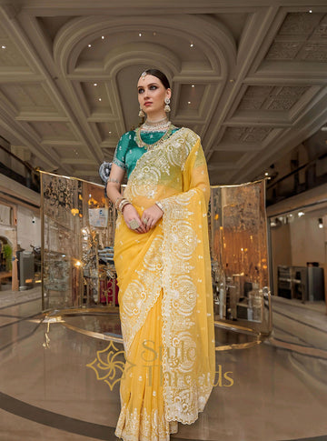 Mesmerizing Yellow Tissue Silk embellished Saree with classic turquoise green hand crafted blouse