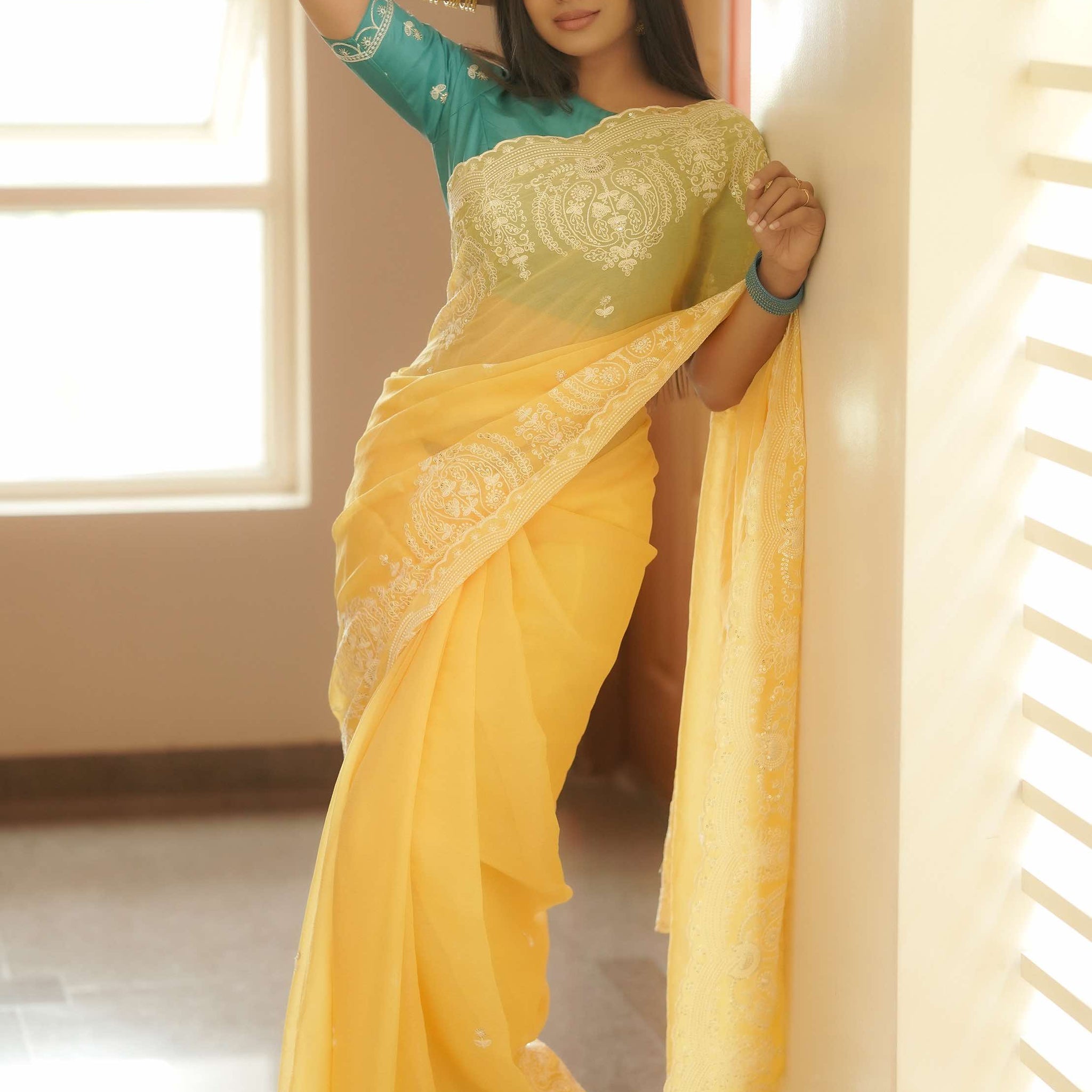 Mesmerizing Yellow Tissue Silk embellished Saree with classic turquoise green hand crafted blouse